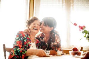 Senior Woman Enjoying a relaxing moment with her Daughter at Home drinking Coffee